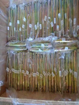Yellow zinc-plated linkage pins packed in an export crate